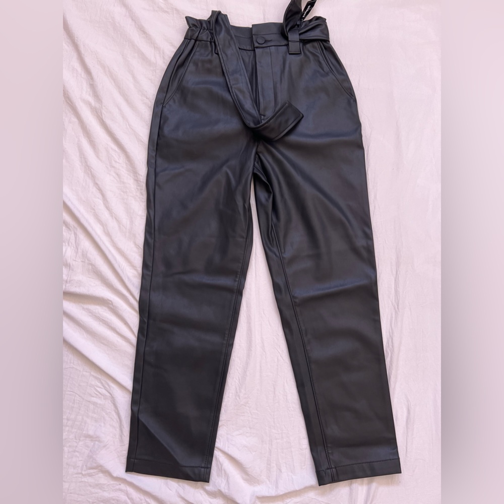 Trendy faux leather pants with belt